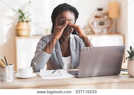 Eye Strain. Overworked Black Businesswoman Massaging Nosebridge At Workplace Having Eyesight Problem