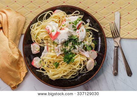 Italian Crab Scampi Over Linguine Pasta With Parsley Garnish