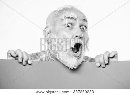 Feathers Madness. Man Bearded Mature Emotional Face With Stuck White Feathers Close Up. Funny Pensio