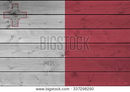 Malta Flag Depicted In Bright Paint Colors On Old Wooden Wall. Textured Banner On Rough Background