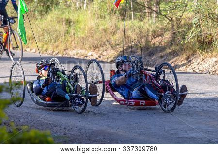 Villa De Leyva, Boyaca, Colombia - December 1, 2019:  Men And Women Of All Ages Ride Bicycles During