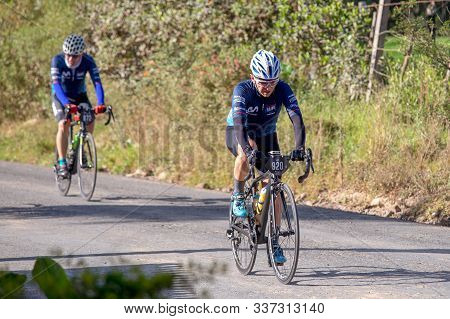 Villa De Leyva, Boyaca, Colombia - December 1, 2019:  Men And Women Of All Ages Ride Bicycles During
