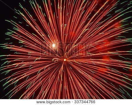 Festive Red Fireworks In The Night Sky Over The City