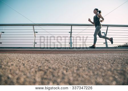 Young Slim Runner Training Outdoors Stock Photo