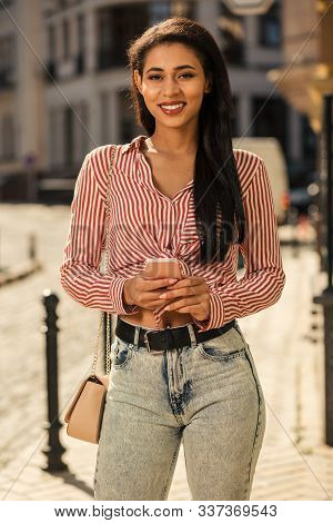 Mirthful Young Lady With Smartphone In Hands Smiling