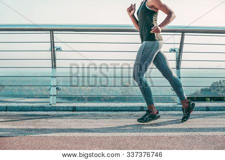 Enthusiastic Runner Outdoors On The Bridge Stock Photo