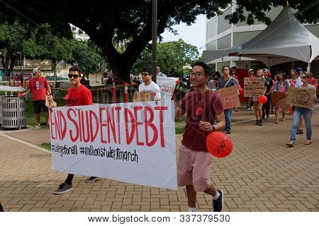 Honolulu - November 12, 2015:  Students Holds Sign Saying End Student Debt On Campus Of The Universi