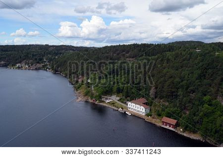 Typical Swedish nature and houses on the shore of the fjord. View from the high bridge over the fjord. The border of Norway and Sweden.Near the town Selater,Sweden