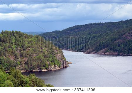 Typical Swedish nature and houses on the shore of the fjord. View from the high bridge over the fjord. The border of Norway and Sweden.Near the town Selater,Sweden