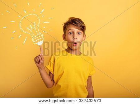 Emotional Child Have A Big Idea. Surprised And Amazed Face Expression. Yellow Background