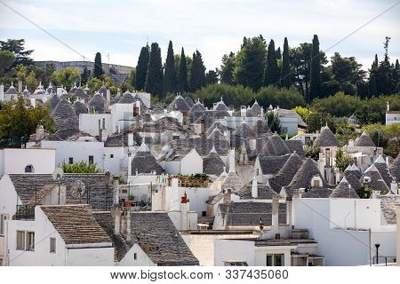 Tradtional White Houses In Trulli Village. Alberobello, Italy. The Style Of Construction Is Specific