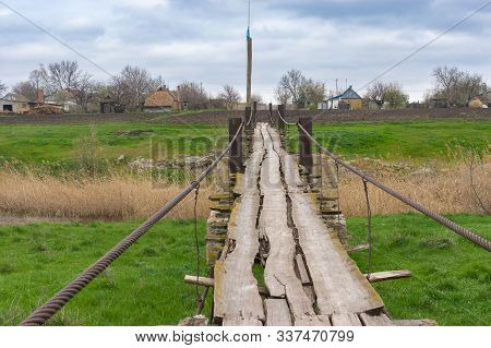 Pedestrian Old Wooden Foot-bridge Over Small River Tomakivka In Topyla Village, Central Ukraine