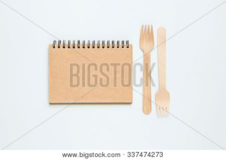Disposable Wooden Forks, Craf Trecipe Notebook On A White Background. Cutlery Made From Natural Mate