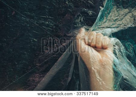 Beautiful Abstract Plastic Cellophane  Bag Background. Human Hand Fist Palm Stop. No Plastic Bag Con