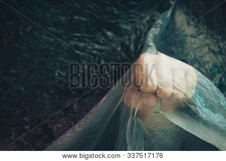 Beautiful Abstract Plastic Cellophane  Bag Background. Human Hand Fist Palm Stop. No Plastic Bag Con