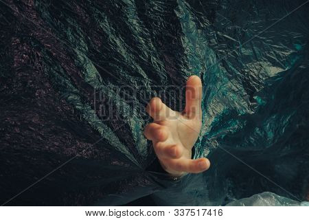Beautiful Abstract Plastic Cellophane  Bag Background. Human Hand Shows Palm Help Stop.  No Plastic 
