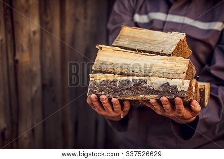 A Pile Of Stacked Firewood, Prepared For Heating The House. Gathering Fire Wood For Winter Or Bonfir