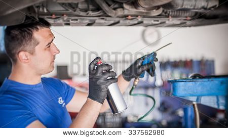 Car Master Mechanic Repairer Lubricates Screws With Machine Cleaner Spray