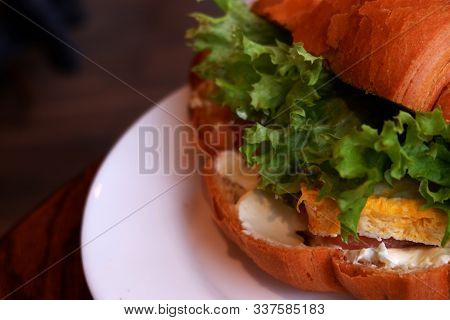 Croissant Sandwiches Served On Wooden Board. Croissants With Egg, Melted Cheese, Parsley, Chicken Ha