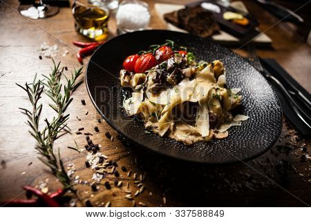 Black Angus pappardelle pasta with beef, champignon and parmegano cheese
