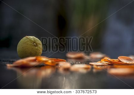 Carrot Face Mask On A Black Wooden Surface Consisting Of Some Freshly Sliced Carrots Paste, Lemon Ju