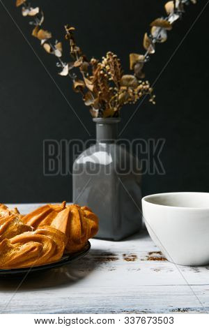 Choux Pastry On A Dark Background. Choux Pastry Eclair With Custard. Against A Dark Background, A Pl