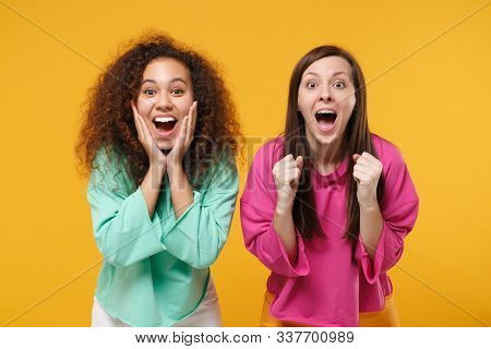 Two Excited Women Friends European African American Girls In Pink Green Clothes Posing Isolated On Y