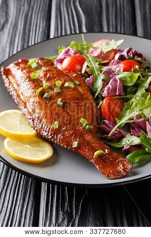 Tasty Whole Fried Sebastes Fish Served With Fresh Vegetable Salad Close-up In A Plate. Vertical