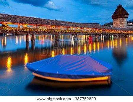Scenic View Of The Chapel, Kapellbrucke Bridge, Wasserturm Tower In The Lantern Light At Sunrise. Lu