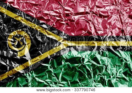 Vanuatu Flag Depicted In Paint Colors On Shiny Crumpled Aluminium Foil Closeup. Textured Banner On R