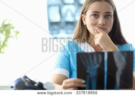 Portrait Of Intern Practicing In Hospital. Beautiful Inexperienced Woman Trying Making Diagnoses Fro