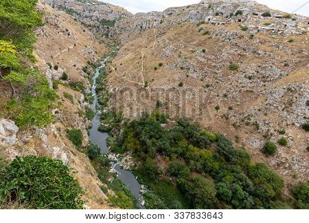 View Of Gravina River Canyon And Park Of The Rupestrian Churches Of Matera With Houses In Caves Di M