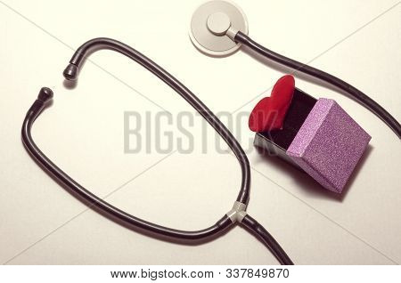 Red Heart In A Gift Box Inside A Statoscope On A White Background.