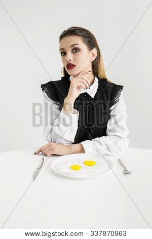 We Are What We Eat. Womans Eating Fried Eggs Made Of Plastic, Eco Concept. There Is So Much Polymers