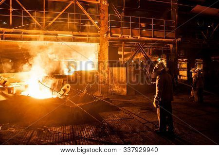 Steelworkers When Pouring Liquid Titanium Slag From Arc Furnace