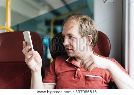 A Smiling Man In A Suburban Train Making A Selfie Shoot By Mobile Phone