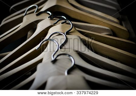 A Row Of Wooden Coathangers Without Clothes