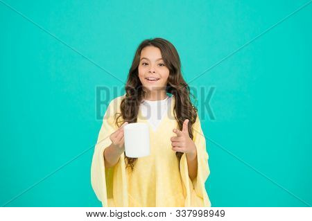 Kid Wearing Soft Poncho Drinking Tea. Little Girl With Long Hair. Feeling Comfy. Adorable Child On T