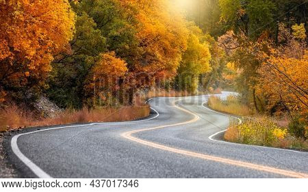 Scenic winding byway Alpine loop in Utah surrounded with brilliant fall foliage