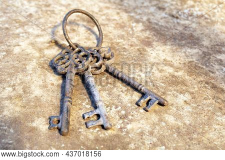 Old Rusty Key On Grunge Background. Vintage Door Keys. Antique Keys On Weathered Rusty Background. A