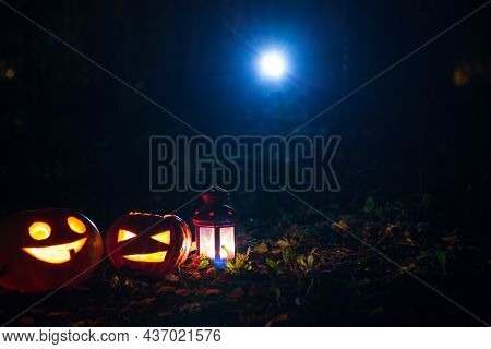 Pumpkin Lights With Candles On The Ground In A Park In The Light Of The Moon. Jack Olantern