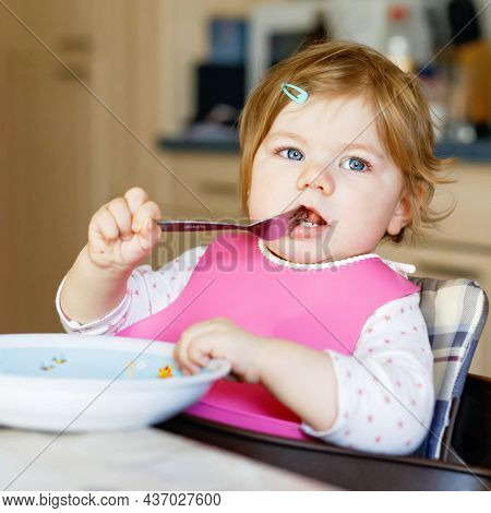 Adorable Baby Girl Eating From Spoon Mashed Vegetables And Puree. Food, Child, Feeding And People Co
