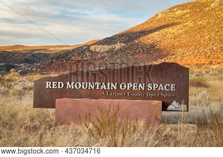 Fort Collins, CO, USA - October 20, 2021: Entry sign to Red Mountain Open Space maintained by Larimer County, fall scenery of Colorado foothills at sunset.