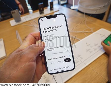 Paris, France - Sep 24, 2021: Man Holding New Iphone 13 At The Apple Store As Latest New 5g Iphone 1
