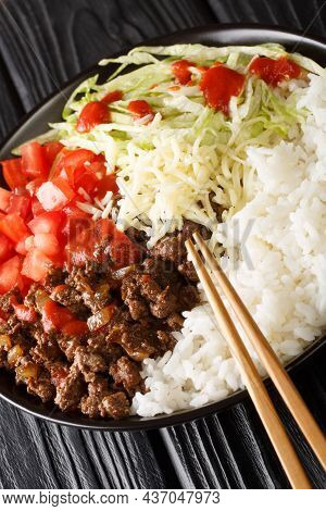 Takoraisu Okinawan Taco Rice With Ground Beef, Vegetables, Cheese And Sauce Close-up In A Bowl On Th