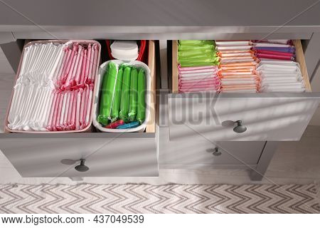 Open Cabinet Drawers With Menstrual Pads, Tampons And Pantyliners Indoors, Above View