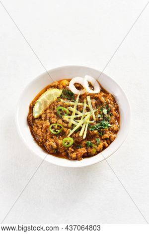 Keema Curry In Bowl Over White Stone Background With Copy Space. Indian And Pakistani Style Dish.