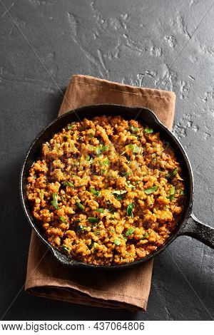 Keema Curry In Frying Pan Over Black Stone Background With Free Text Space. Indian And Pakistani Sty