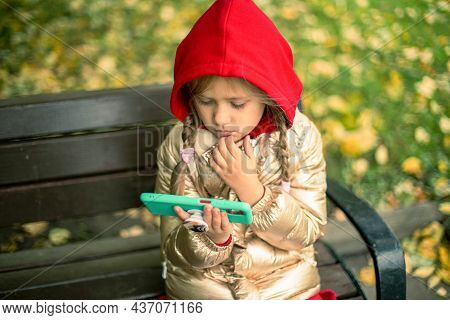A Girl With A Phone On The Street.
