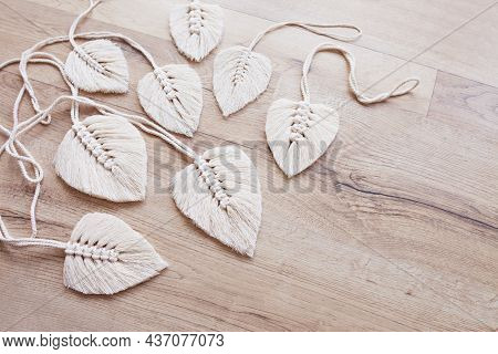 Macrame Leaves In Natural Color On The Wooden Background. Cotton Rope Decor Macrame To Make Your Hom